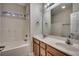 Bathroom featuring a double sink vanity, a tub and shower combo, and ample lighting at 422 South Poplar Dr., Surfside Beach, SC 29575