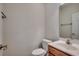 Bright powder room featuring a pedestal sink and framed mirror at 422 South Poplar Dr., Surfside Beach, SC 29575