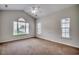 Bright, carpeted primary bedroom with multiple windows and a vaulted ceiling at 422 South Poplar Dr., Surfside Beach, SC 29575