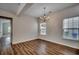 Cozy dining area featuring a chandelier, wood flooring, and two windows that provide natural light at 422 South Poplar Dr., Surfside Beach, SC 29575