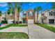 Charming two-story home with a brick facade, attached garage, and mature palm trees in the front yard at 422 South Poplar Dr., Surfside Beach, SC 29575