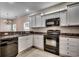 Functional kitchen with white cabinets, black appliances, and ample countertop space at 422 South Poplar Dr., Surfside Beach, SC 29575