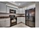 Well-equipped kitchen with white cabinets, black appliances, and a sleek design at 422 South Poplar Dr., Surfside Beach, SC 29575