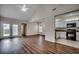 Open-concept living room boasts wood floors, vaulted ceilings, and an adjacent kitchen and dining area at 422 South Poplar Dr., Surfside Beach, SC 29575