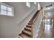 Carpeted staircase with white railings and natural wood accents at 422 South Poplar Dr., Surfside Beach, SC 29575
