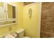 Well-lit bathroom featuring a white vanity, toilet, shower with tiled walls and built in shelves at 4516 Seaview St. # 137, North Myrtle Beach, SC 29582