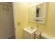 Well-lit bathroom featuring a white vanity, toilet, and convenient storage shelves at 4516 Seaview St. # 137, North Myrtle Beach, SC 29582