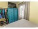 Bedroom with a bed, blue wardrobe, and clothes rack, offering ample storage and a tidy living space at 4516 Seaview St. # 137, North Myrtle Beach, SC 29582