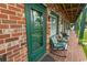 Charming brick-clad building with a green door and inviting outdoor seating at 4516 Seaview St. # 137, North Myrtle Beach, SC 29582