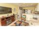 Living room and kitchen combo with tile floors, an entertainment center, and kitchen appliances at 4516 Seaview St. # 137, North Myrtle Beach, SC 29582