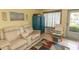 Living room featuring neutral-toned furniture, tile floors, an accent cabinet, and an exterior door at 4516 Seaview St. # 137, North Myrtle Beach, SC 29582
