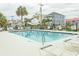 A refreshing pool surrounded by lounge chairs and lush palm trees, perfect for relaxation at 4516 Seaview St. # 137, North Myrtle Beach, SC 29582