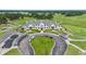 Aerial view of the clubhouse with neatly manicured lawns and golf cart parking, surrounded by a golf course at 4574 Girvan Dr. # D, Myrtle Beach, SC 29579