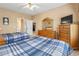 Bedroom with two beds, ceiling fan, dresser, and access to bathroom and kitchen at 4574 Girvan Dr. # D, Myrtle Beach, SC 29579