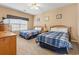 Comfortable bedroom featuring twin beds with blue bedding, a window, and a dresser for ample storage at 4574 Girvan Dr. # D, Myrtle Beach, SC 29579