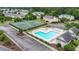 An aerial view of the community pool and tennis courts with a surrounding parking lot and landscaped areas at 4574 Girvan Dr. # D, Myrtle Beach, SC 29579