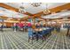 The spacious dining room features a wooden beam ceiling, stylish chandeliers, and a plaid carpet at 4574 Girvan Dr. # D, Myrtle Beach, SC 29579