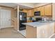 Well-equipped kitchen showcasing ample wood cabinetry and modern black appliances, ideal for cooking and entertaining at 4574 Girvan Dr. # D, Myrtle Beach, SC 29579