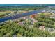 An aerial view shows a waterfront condo community featuring lush landscaping and waterway access at 4648 Greenbriar Dr. # D2, Little River, SC 29566