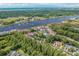 An aerial view shows the condo community near waterway, lush green trees and the ocean in the distance at 4648 Greenbriar Dr. # D2, Little River, SC 29566