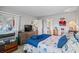 Bright bedroom with nautical themed-bedding, a sliding glass door, and a glimpse into the bathroom and kitchen at 4648 Greenbriar Dr. # D2, Little River, SC 29566
