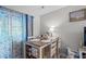 Cozy dining area with modern table, seating for four, and decorative curtains at 4648 Greenbriar Dr. # D2, Little River, SC 29566