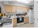 Efficient kitchen featuring light wood cabinets, white countertop and all necessary appliances at 4648 Greenbriar Dr. # D2, Little River, SC 29566