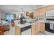 Cozy kitchen boasts light wood cabinets, white countertops and open access to the living room at 4648 Greenbriar Dr. # D2, Little River, SC 29566