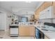 A well-lit kitchen with wood cabinets, white countertops, and seamless access to the adjacent living area at 4648 Greenbriar Dr. # D2, Little River, SC 29566