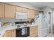 Traditional kitchen with light wood cabinetry, a white refrigerator and practical appliances at 4648 Greenbriar Dr. # D2, Little River, SC 29566