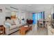 Comfortable living room with modern seating, blue curtains, and dining area adjacent at 4648 Greenbriar Dr. # D2, Little River, SC 29566