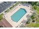Aerial view of a community pool surrounded by lounge chairs and palm trees in a well-maintained community at 4648 Greenbriar Dr. # D2, Little River, SC 29566