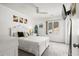 Bright bedroom featuring white walls, carpeted floors, a ceiling fan, and a window with a view of the outside at 502 Garden Dr., Surfside Beach, SC 29575