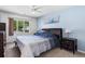 Cozy bedroom featuring cool blue walls, a ceiling fan, and a large window at 502 Garden Dr., Surfside Beach, SC 29575