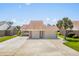 Wide shot of a brick home with a three car garage and large concrete driveway at 502 Garden Dr., Surfside Beach, SC 29575