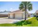 Spacious three-car garage with ample parking and storage, highlighted by a palm tree in the front yard at 502 Garden Dr., Surfside Beach, SC 29575