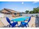 Inviting in-ground pool with lounge chairs, hot tub, and well-maintained brick home and backyard at 502 Garden Dr., Surfside Beach, SC 29575