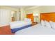 Bedroom featuring two beds, bedside lamps, and a glimpse into the bathroom at 504 N Ocean Blvd. # 1804 A/B, Myrtle Beach, SC 29577