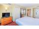 Bedroom featuring closet, TV on dresser and open door to an en suite bathroom at 504 N Ocean Blvd. # 1804 A/B, Myrtle Beach, SC 29577