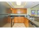 Well-equipped kitchen with granite countertops, wood cabinets, and modern appliances at 504 N Ocean Blvd. # 1804 A/B, Myrtle Beach, SC 29577