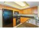 Fully equipped kitchen with wood cabinets, granite countertops, and stainless steel appliances at 504 N Ocean Blvd. # 1804 A/B, Myrtle Beach, SC 29577