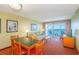 Welcoming living room with dining table, sofa and access to balcony with ocean views at 504 N Ocean Blvd. # 1804 A/B, Myrtle Beach, SC 29577