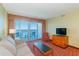Inviting living room with a comfortable sofa, TV, and access to a balcony with an ocean view at 504 N Ocean Blvd. # 1804 A/B, Myrtle Beach, SC 29577
