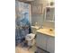 Compact bathroom with toilet, sink, and patterned shower curtain at 523 S Ocean Blvd. # 705, North Myrtle Beach, SC 29582