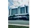 Exterior shot of a multistory condo building, showcasing architecture and entry at 523 S Ocean Blvd. # 705, North Myrtle Beach, SC 29582