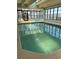 Bright indoor pool with floor to ceiling windows and sun loungers at 523 S Ocean Blvd. # 705, North Myrtle Beach, SC 29582