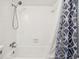 Bright bathtub with shower head featuring white square tiles and a patterned shower curtain at 5409 North Ocean Blvd. # 106/7108, North Myrtle Beach, SC 29582