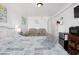 Comfortable bedroom featuring a queen-sized bed, loveseat, chest of drawers, and mini-fridge at 5409 North Ocean Blvd. # 106/7108, North Myrtle Beach, SC 29582