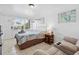Inviting bedroom featuring a queen-sized bed, loveseat, and beach-themed decor at 5409 North Ocean Blvd. # 106/7108, North Myrtle Beach, SC 29582