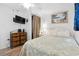 Inviting bedroom featuring coastal artwork, a TV, and a wicker dresser at 5409 North Ocean Blvd. # 106/7108, North Myrtle Beach, SC 29582